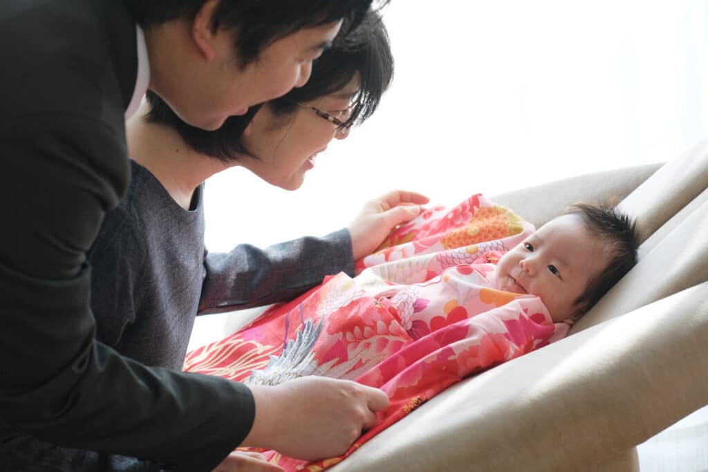 a man and woman looking at a baby