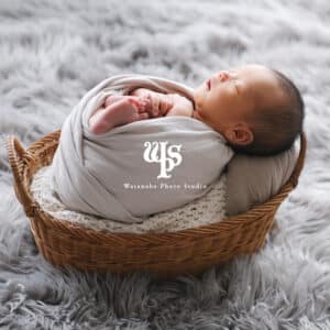 a baby sleeping in a basket