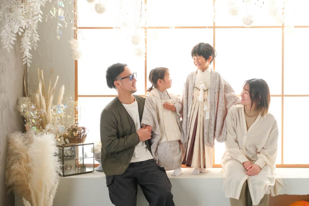 a group of people standing in front of a window