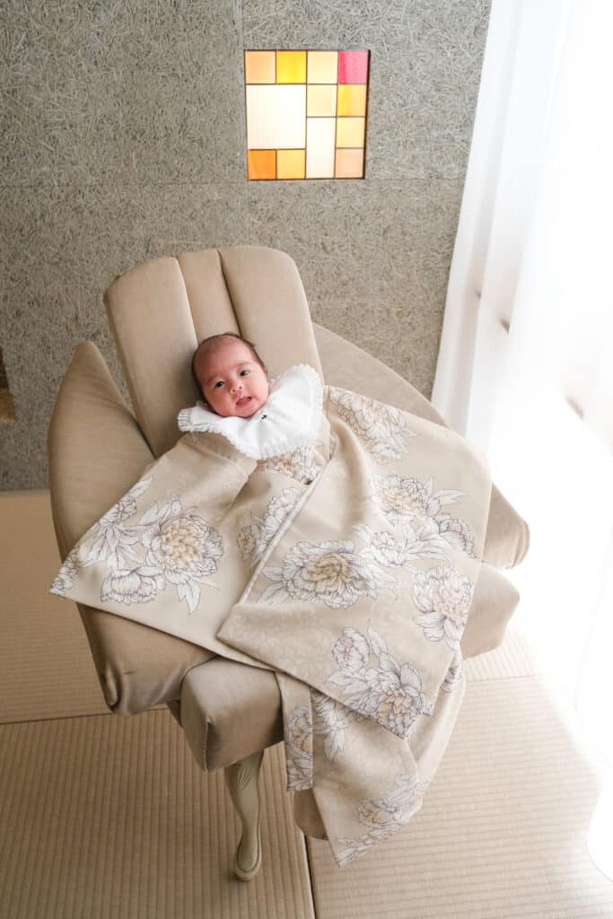 a baby lying on a chair