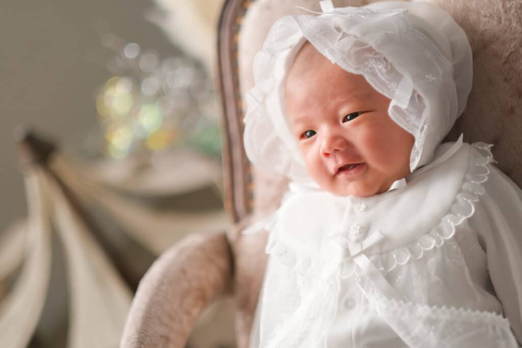 a baby in a white bonnet